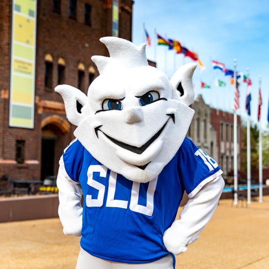 The Billiken posing for a photo on campus