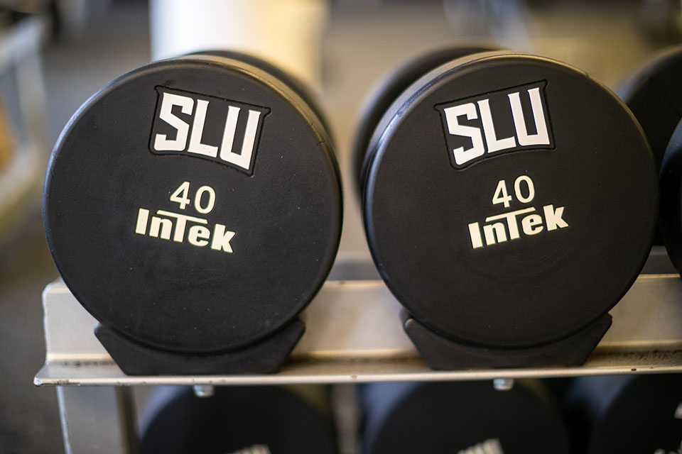 A pair of hand weights with SLU on them