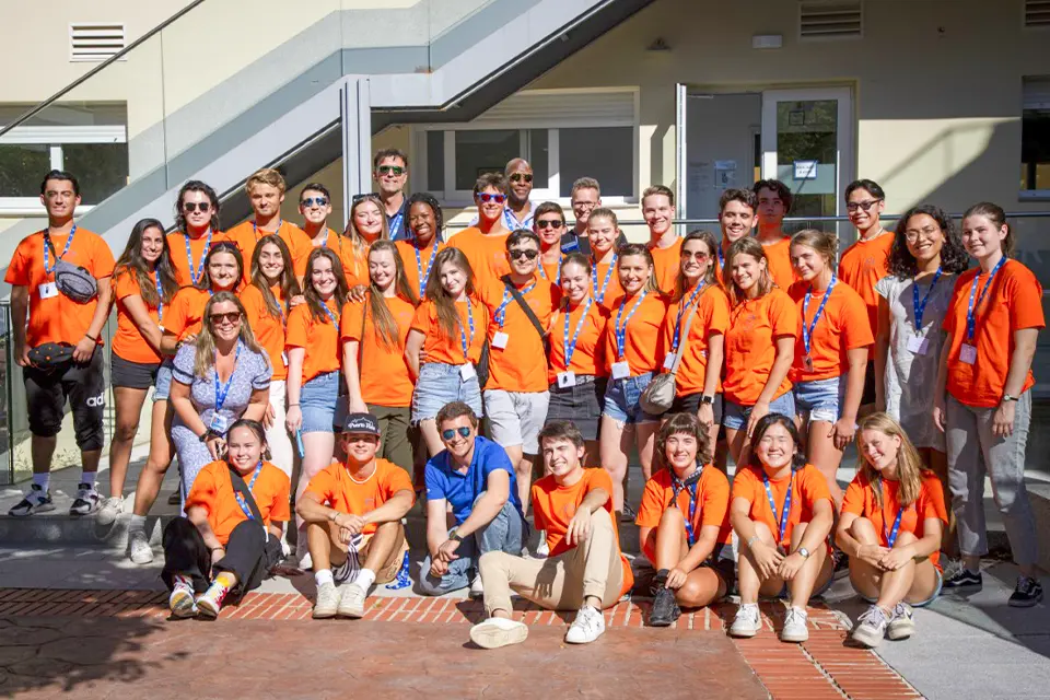 A large group of campus ambassador students pose outdoors on the SLU madrid campus. 