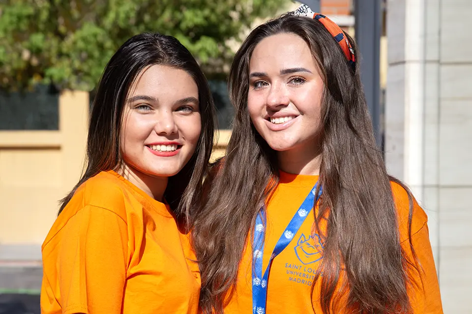 Two campus ambassadors pose for a photo outdoors on the SLU Madrid campus.