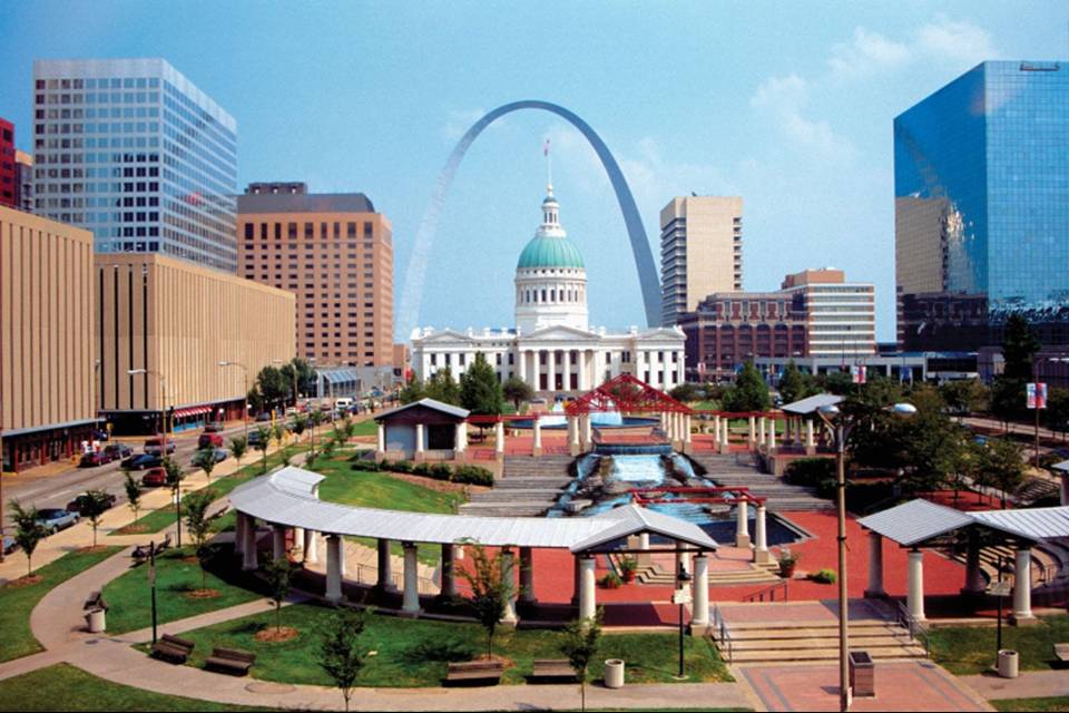 View of downtown St Louis with the arch centered over the old courthouse on a sunny day