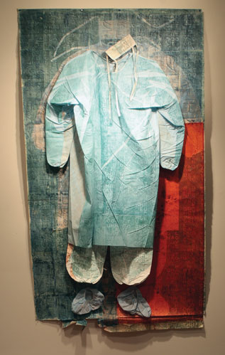An artwork by Horatio Hung-Yan Law titled Meditations on the Way of the Cross in the Time of AIDS: The Psalms for the Bridegroom’s Widower. A surgeon's protective scrubs are mounted on a large piece of paper that is mostly blue, but the lower right quadrant is red. Small letters forming various words are printed in grid-like formations across the whole work.