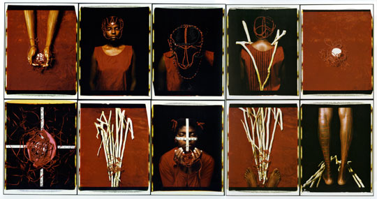 An artwork by Maria Magdalena Campos-Pons titled, Abridor de Caminos (The One Who Opens the Path). Ten photographs are arranged in a grid five across and two deep. Several depict a woman in a red dress with ornate braids in her hair, while others depict white sticks, stones, and other ritual items.