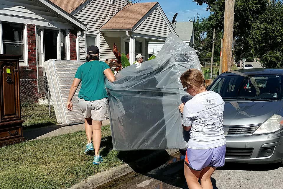 Rimmerman and other volunteers help someone move in