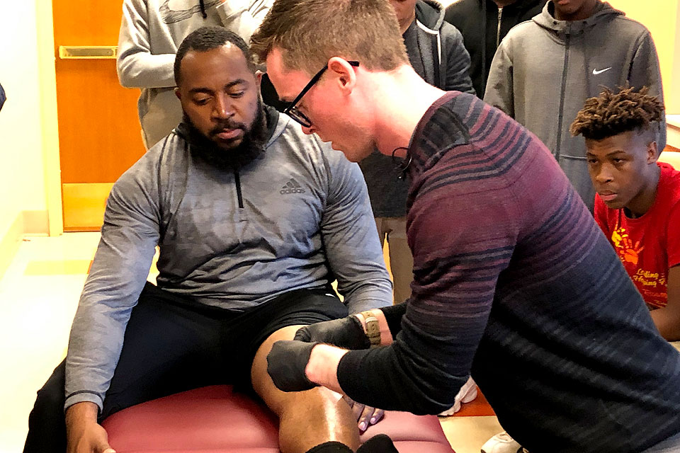 Adam Long demonstrates a sports medicine technique