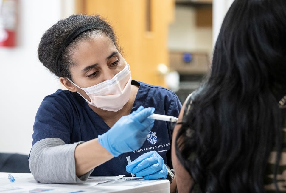 Nursing student vaccinates a patient