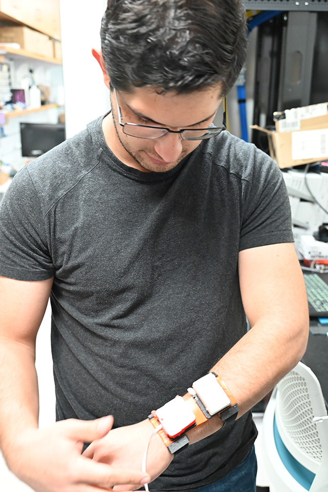 Nicolas Prudencio adjusts the wearable haptic device.