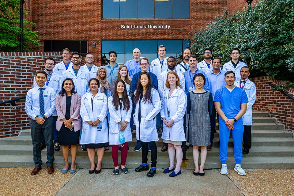 Faculty and residents in front of LRC stairs