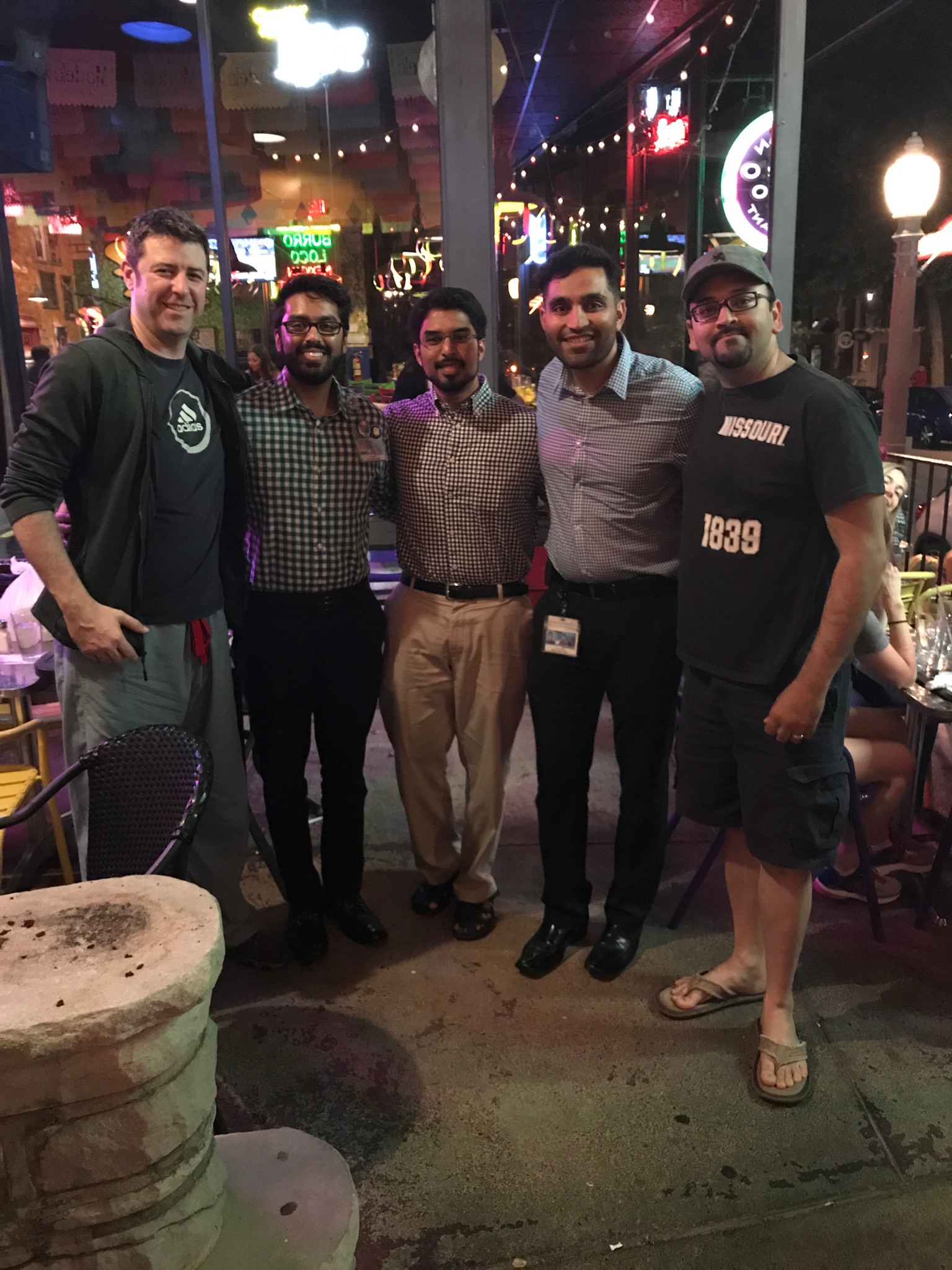 Slide 5 photo of small group of child neurology residents together outdoors