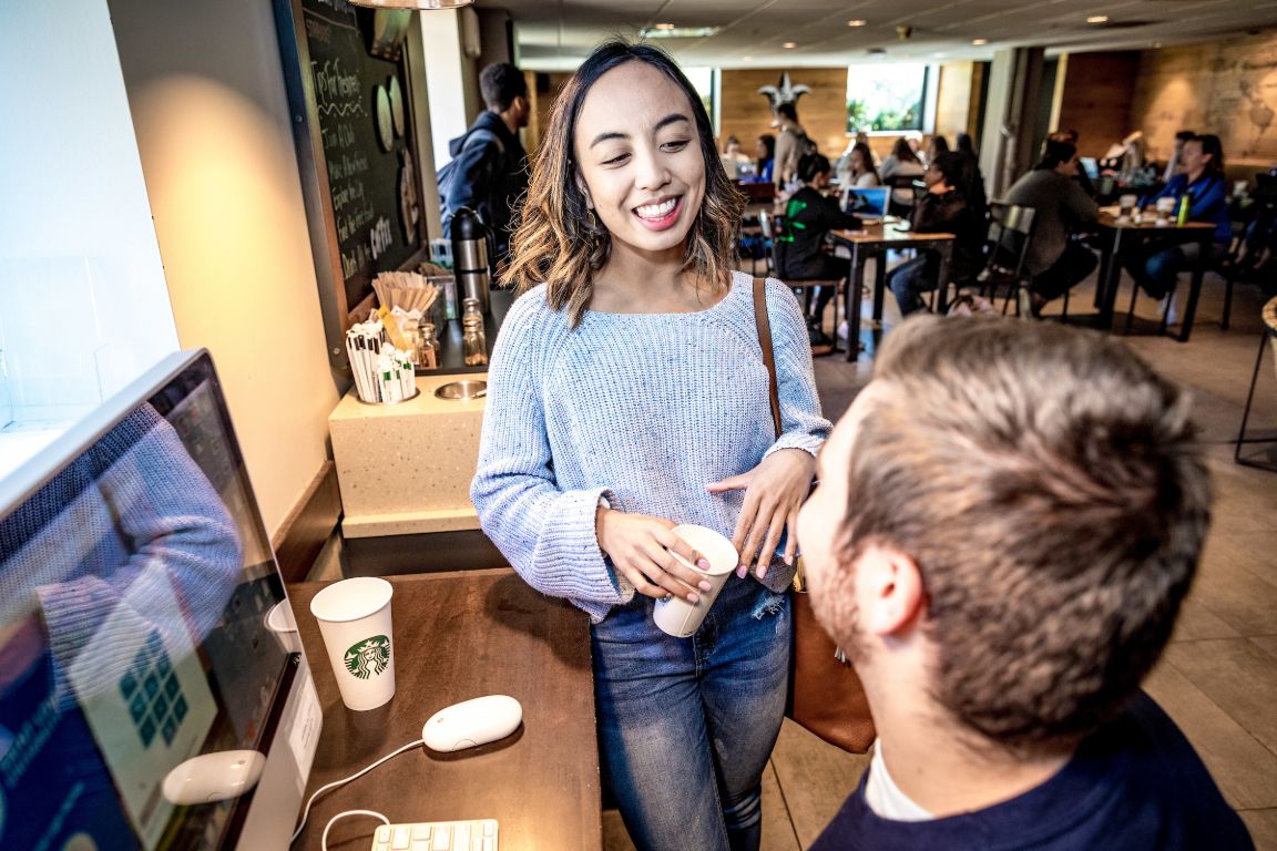 Students enjoying the Starbucks on the ground floor of Clemens Hall.