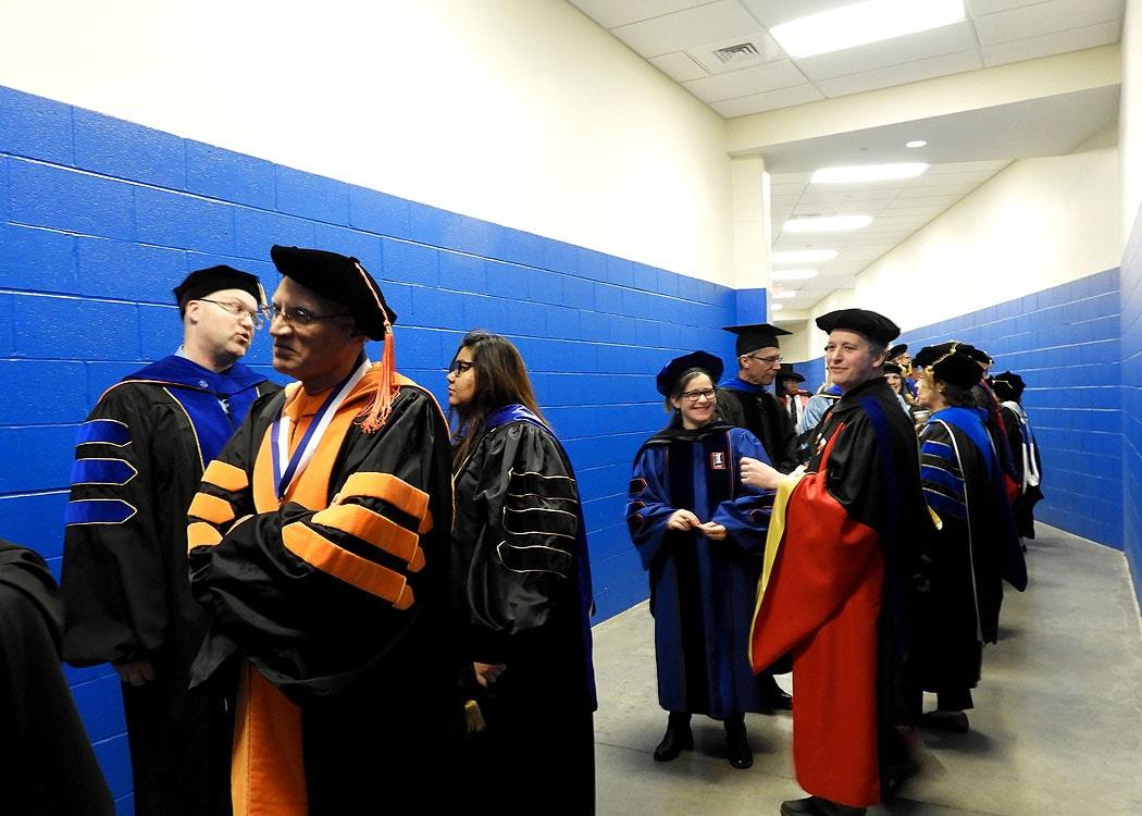 Faculty prepare to walk at commencement.