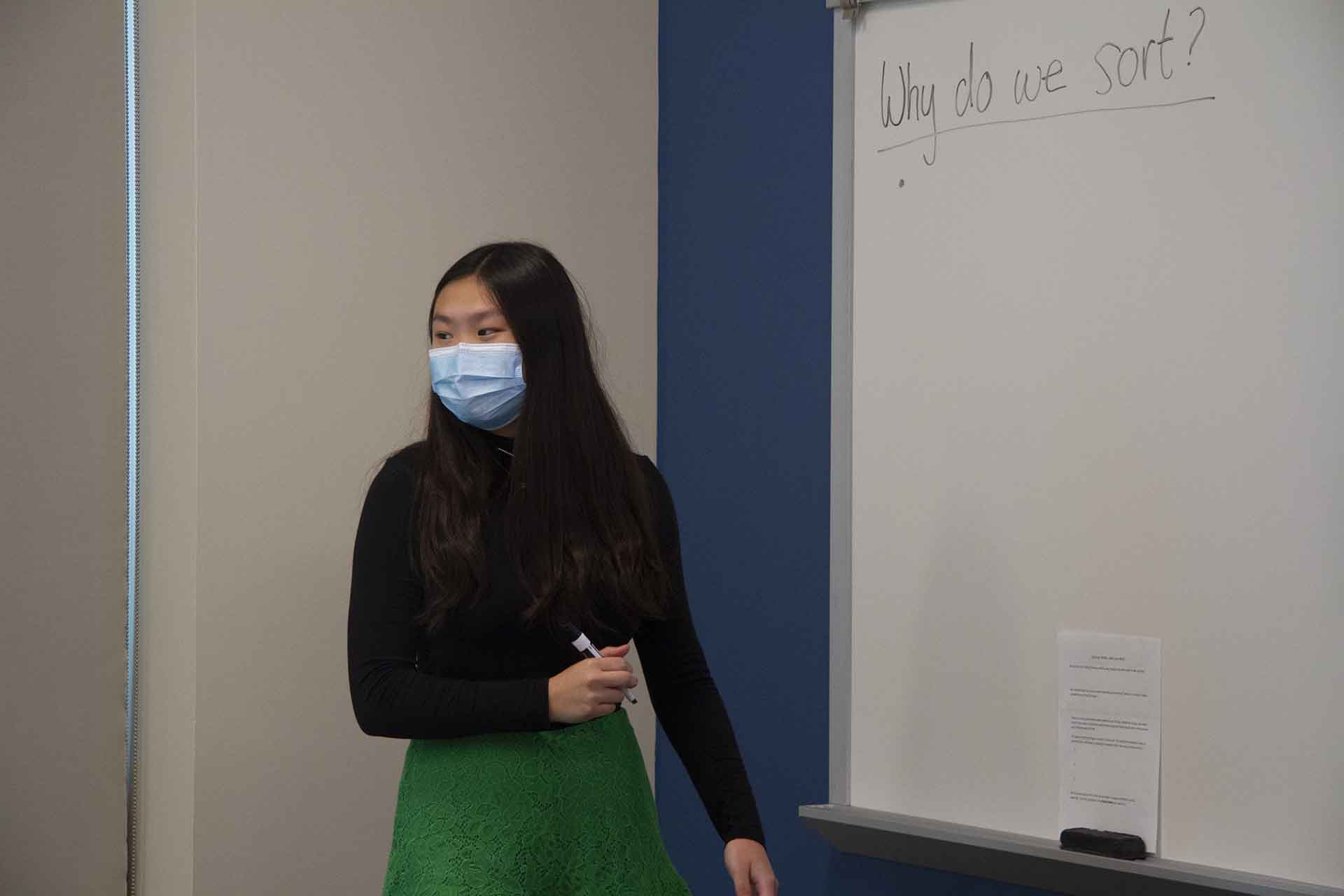 A SLU professor prepares to write on the board during a class discussion.