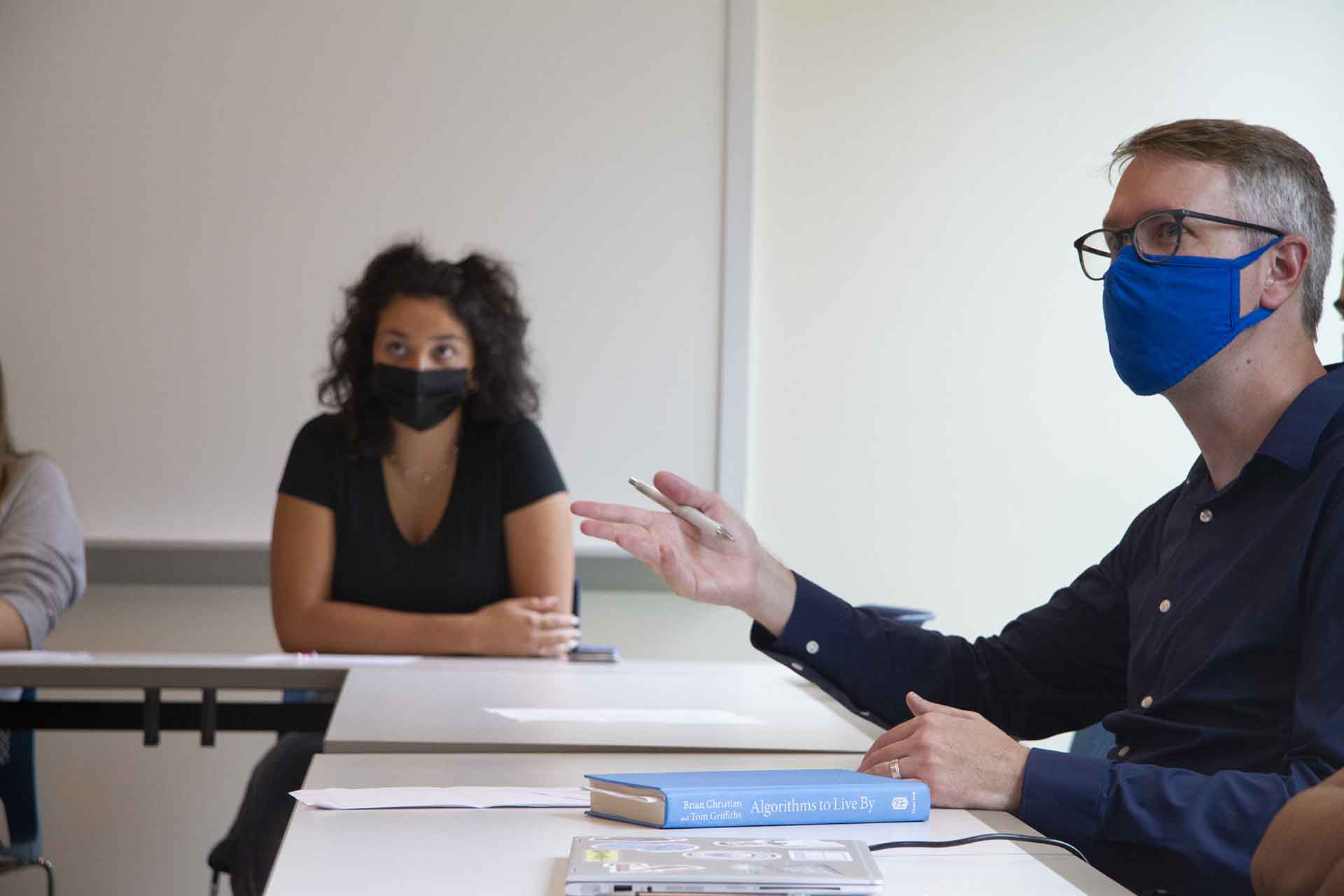 Students hold a discussion in a classroom.