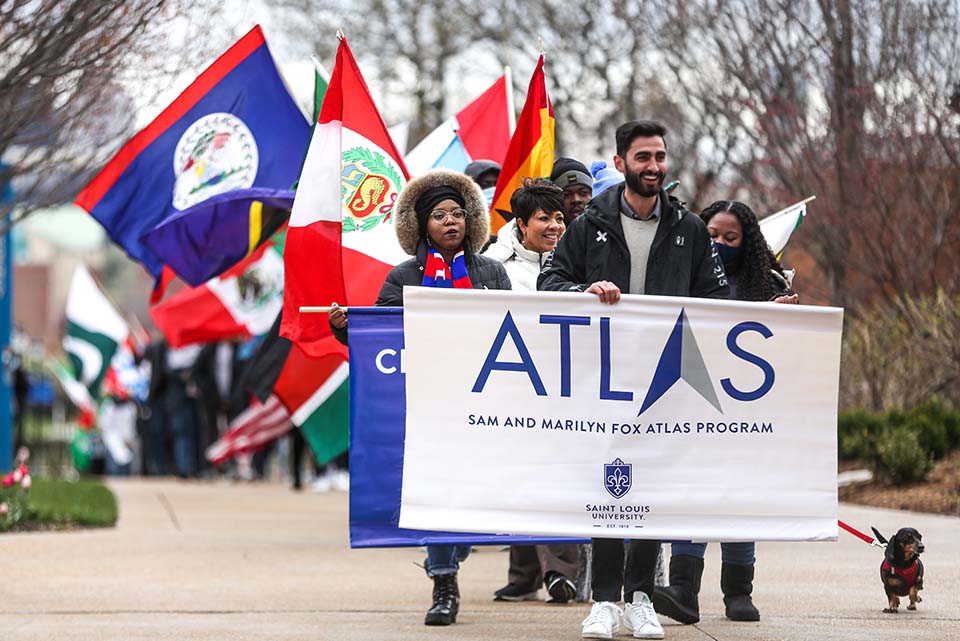 The Parade of Nations kicks off the Billiken World Festival during Atlas Week on April 8 with members of the SLU community carrying flags from around the world. Photo by Sarah Conroy. 
