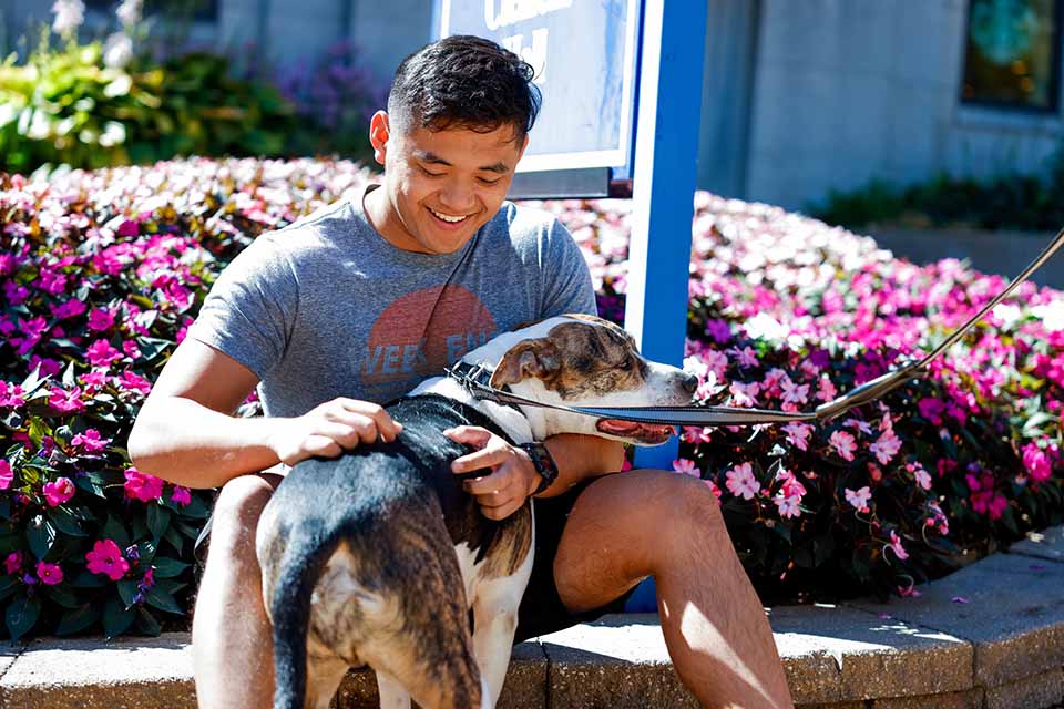 Noah Sioson pets Kai during Wellness Day on September 28, 2022. Classes were cancelled and a variety of activities were planned to promote students’ wellbeing.

