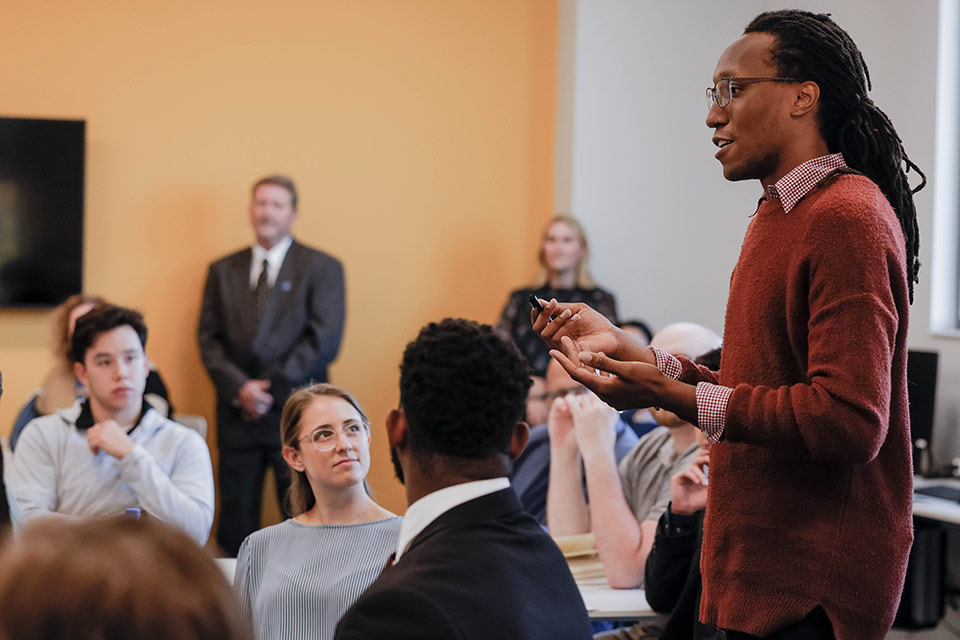 Donivan James, a graduate student in geospatial sciences at SLU, speaks to U.S. Director of National Intelligence Avril Haines and NGA Director Vice Admiral Frank Whitworth during a student event Oct. 12. Photo by Sarah Conroy.