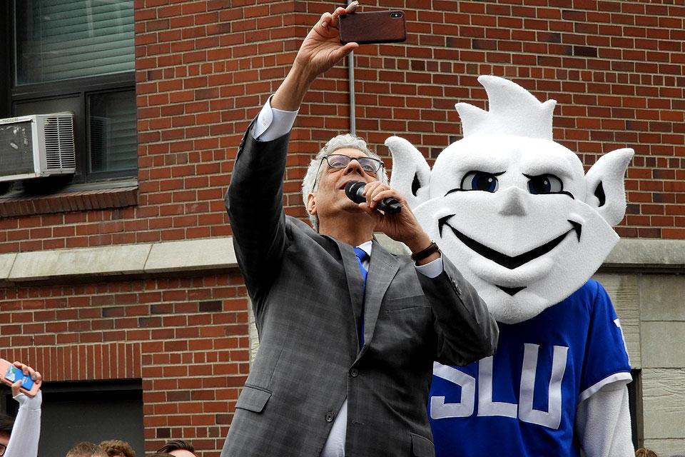 University President Fred P. Pestello, Ph.D., starts the drawing with a Billiken selfie.