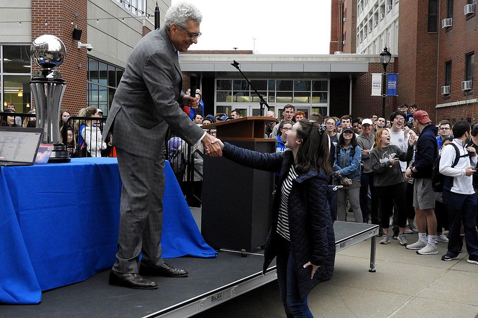 University President Fred P. Pestello, Ph.D., congratulates a lottery winner.
