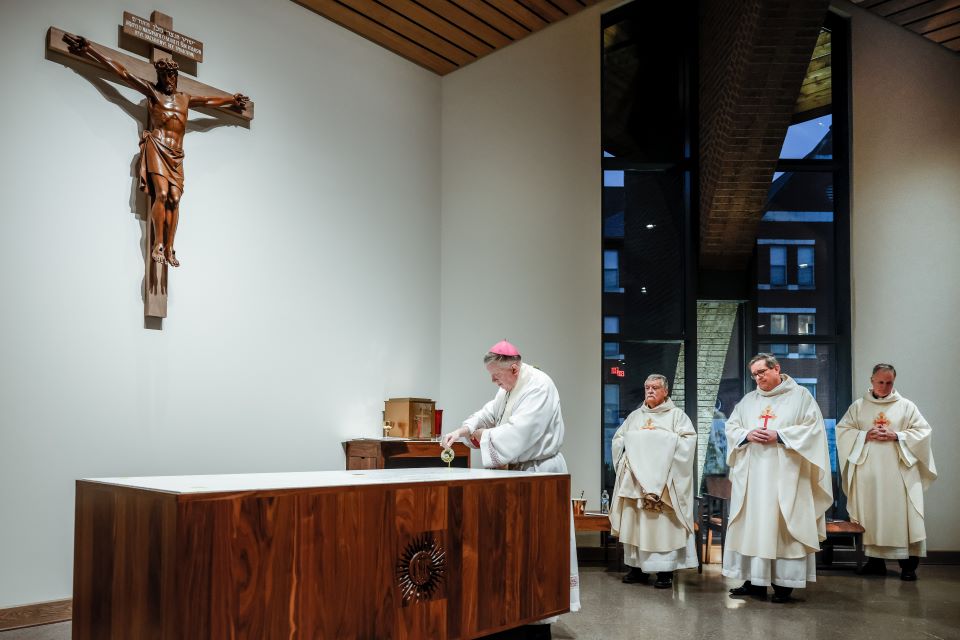Archbishop Mitchell T. Rozanski pours chrism to consecrate the altar of the Jesuit Center Chapel on October 25, 2022. Photo by Sarah Conroy. 