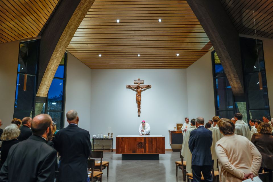 Archbishop Mitchell T. Rozanski pours chrism to consecrate the altar of the Jesuit Center Chapel on October 25, 2022. Photo by Sarah Conroy. 