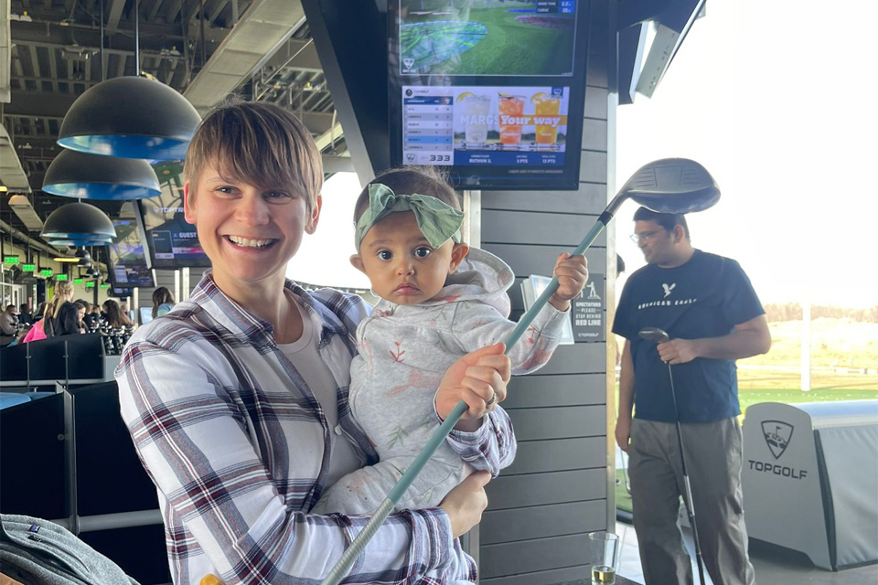 Our associate program Director mingling with a fellow's baby at TopGolf
