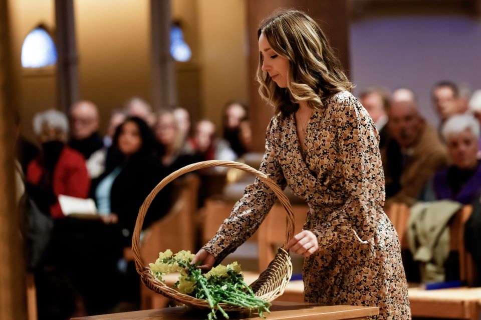 Members of the SLU Medicine class of 2026 offer flowers for the loved ones who donated their bodies to the Gift Body Program during the Interfaith Memorial Service at St. Francis Xavier College Church on November 11, 2022. Photo by Sarah Conroy. 