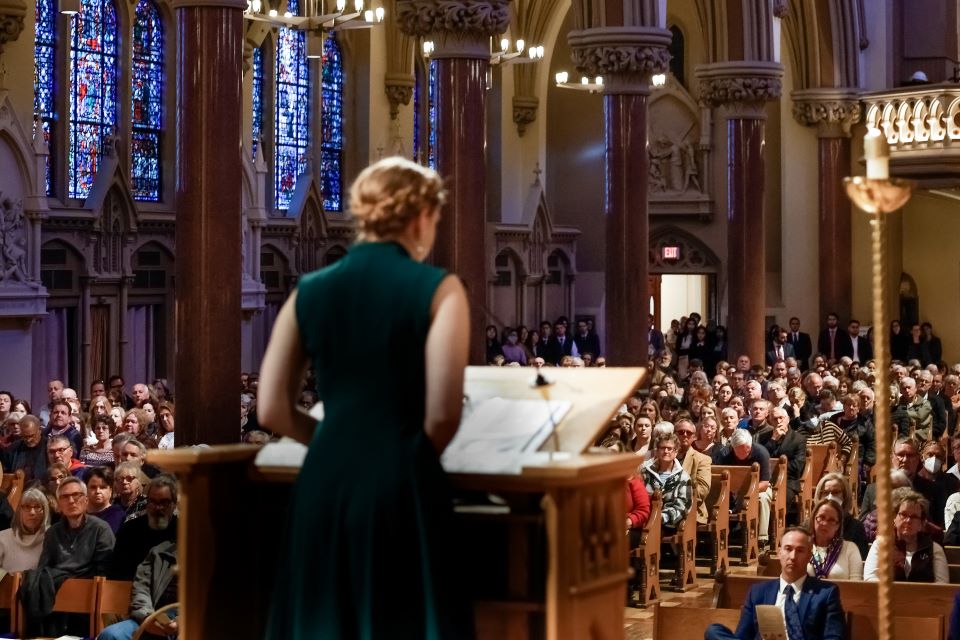 Student Savannah England reads a reflection during the interfaith memorial service at St. Francis Xavier College Church on November 11.  The service honors loved ones who have donated their bodies to the School of Medicine through the Gift Body Program.  Photo by Sarah Conroy.