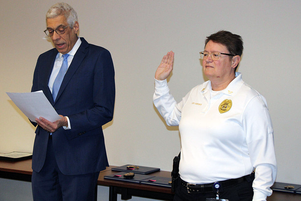 Melinda Heikkinen, AVP/Chief of Public Safety, takes an oath of affirmation with SLU President Fred P. Pestello, Ph.D. The SLU Department of Public Safety held its first pinning ceremony on Wednesday, Nov. 16, 2022. 
