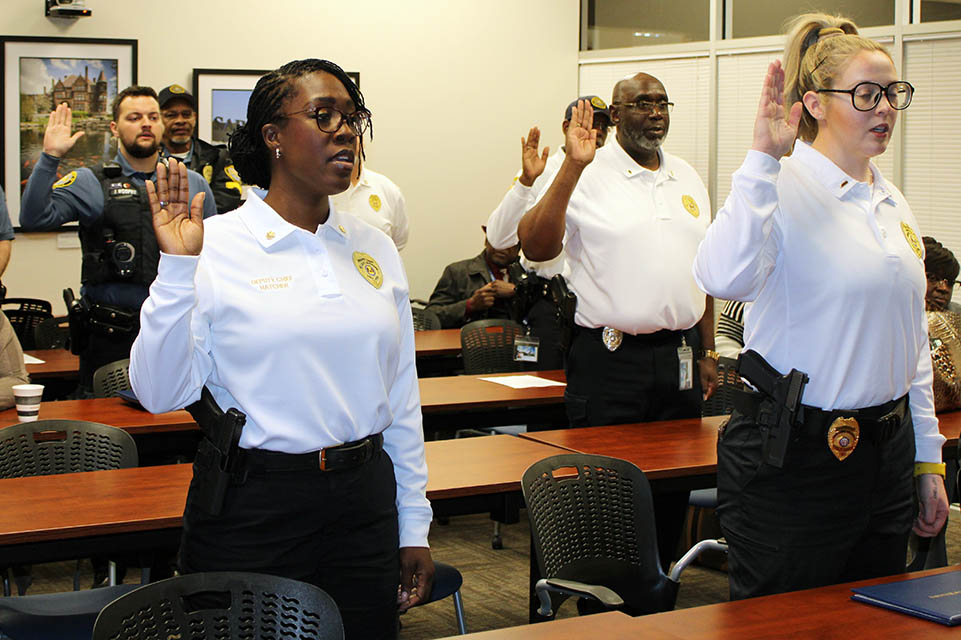 Saint Louis University Department of Public Safety Officers recite an oath of affirmation during a ceremony on Wednesday, Nov. 16, 2022. Photo by Joe Barker. 
