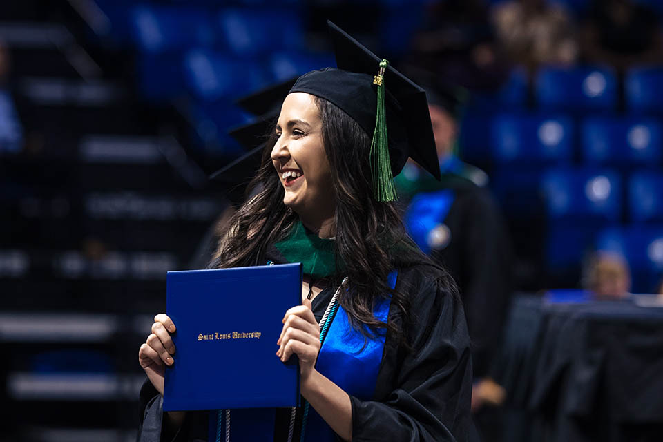 A graduate shows off her diploma cover during the 2022 Midyear Commencement ceremony at Chaifetz Arena on Saturday, Dec. 17, 2022. Photo by Sarah Conroy.