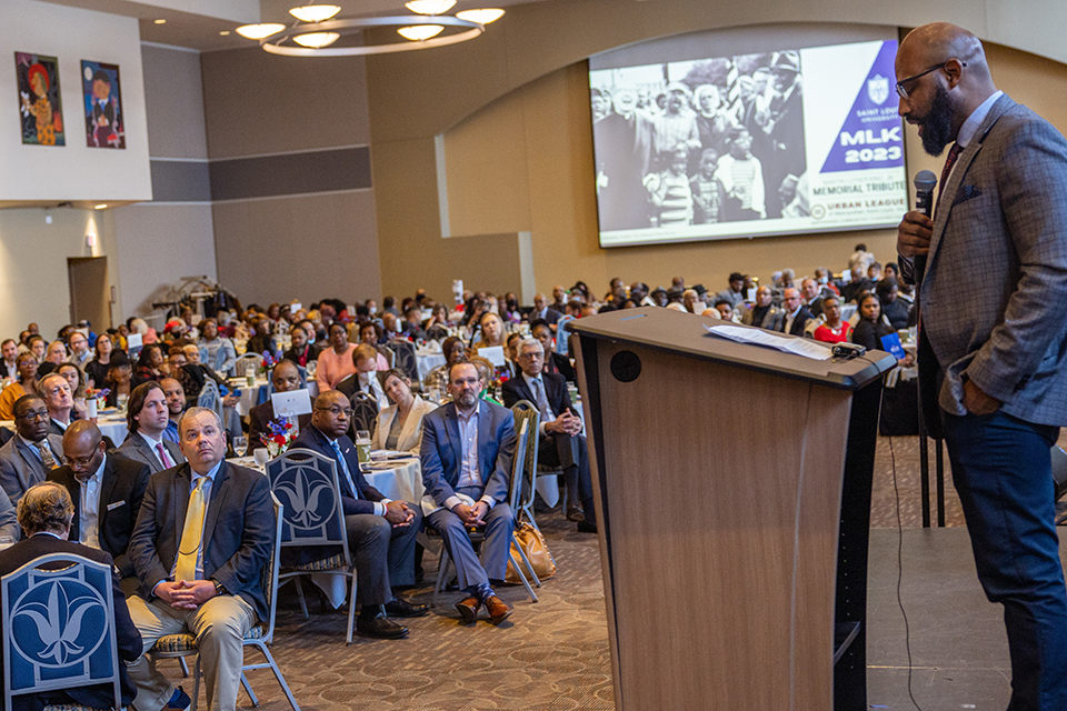 Christopher Tinson, Ph.D., associate professor of history and chair of the African American Studies Department at SLU, speaks during the Martin Luther King Jr. Memorial Tribute hosted by Saint Louis University and the Urban League of Metropolitan St. Louis on Jan. 11, 2023. Photo by Sarah Conroy.
