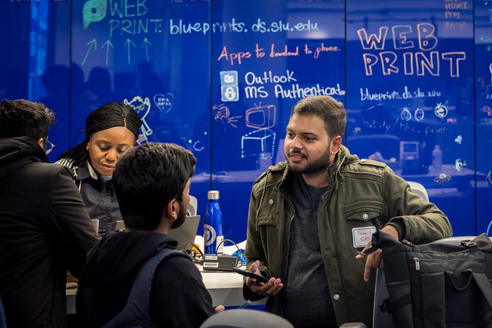Incoming international students visit the AskSlu desk in Pius XII Memorial Library during International Student Orientation on Jan. 12, 2023. Photo by Sarah Conroy. 