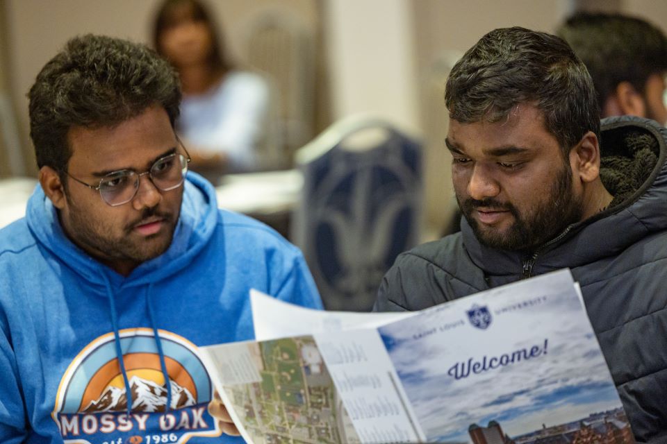Incoming international students look at a welcome packet during the International Student Orientation on Jan. 12, 2023. Photo by Sarah Conroy. 