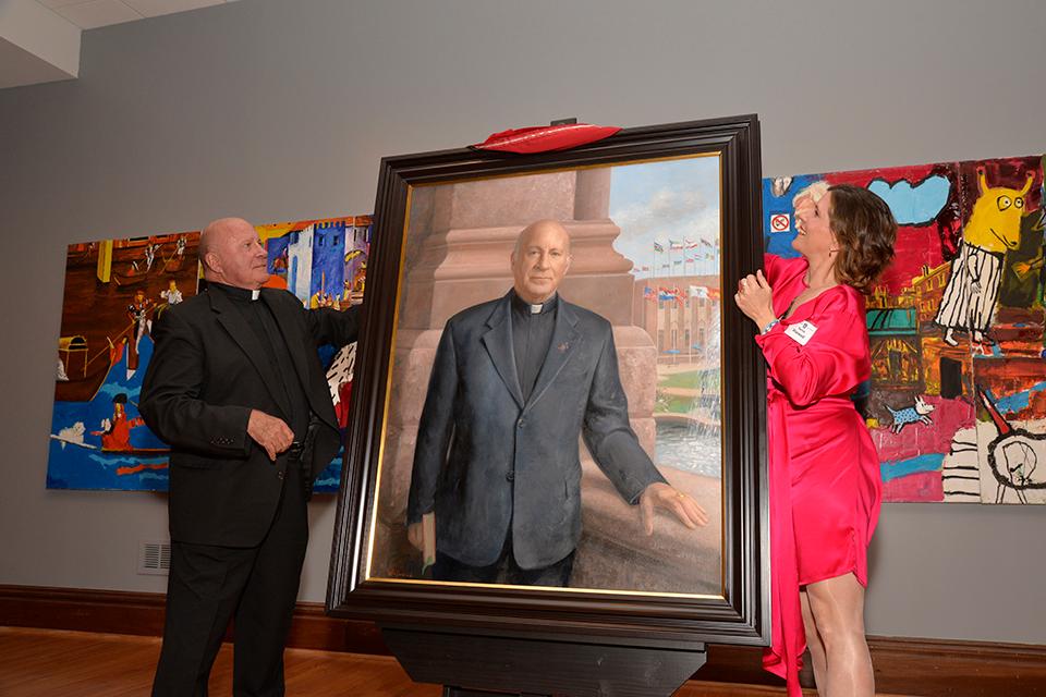Father Biondi and artist Patricia Watwood unveil his official Saint Louis University portrait.