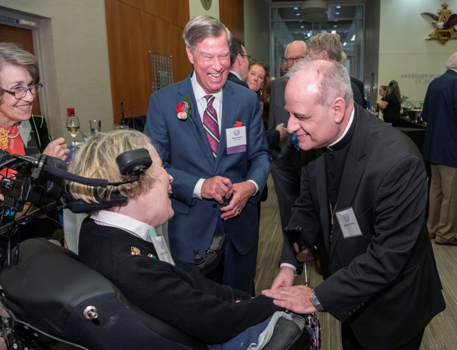 Archbishop greets guest at Order of the Fleur de Lis Hall of Fame