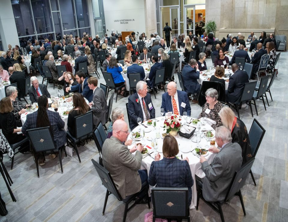 Guests sit for dinner at Scott Hall