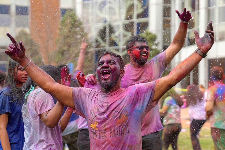 A large group of students gathered on the DuBourg Hall quad on Sunday, March 5, for a Holi celebration. Holi is a Hindu festival of colors. The event was organized by the Office of International Services. Photo by Cristina Fletes.