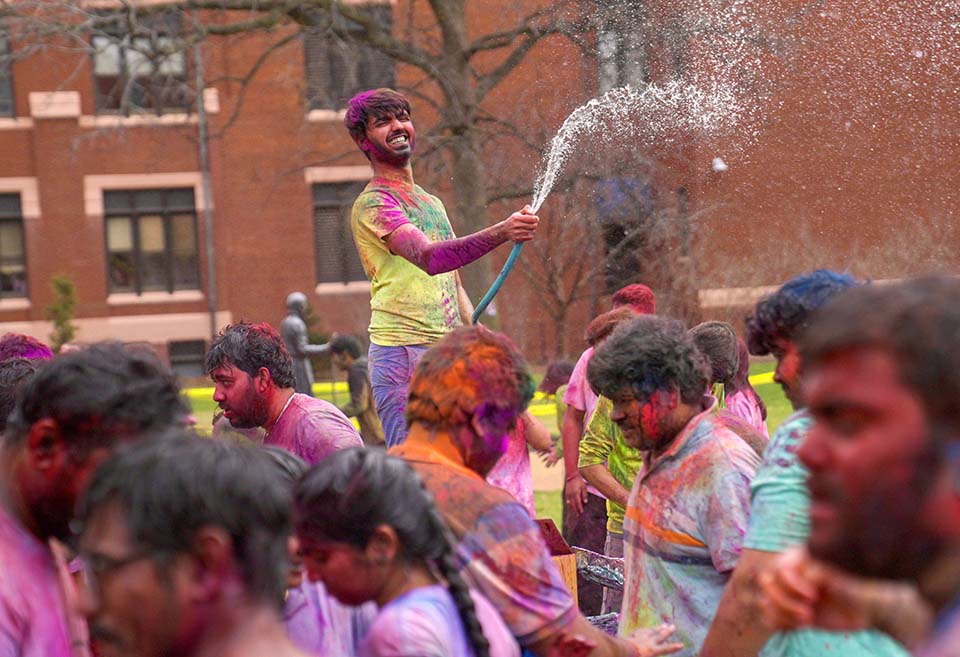 A large group of students gathered on the DuBourg Hall quad on Sunday, March 5, for a Holi celebration. Holi is a Hindu festival of colors. The event was organized by the Office of International Services. Photo by Cristina Fletes.