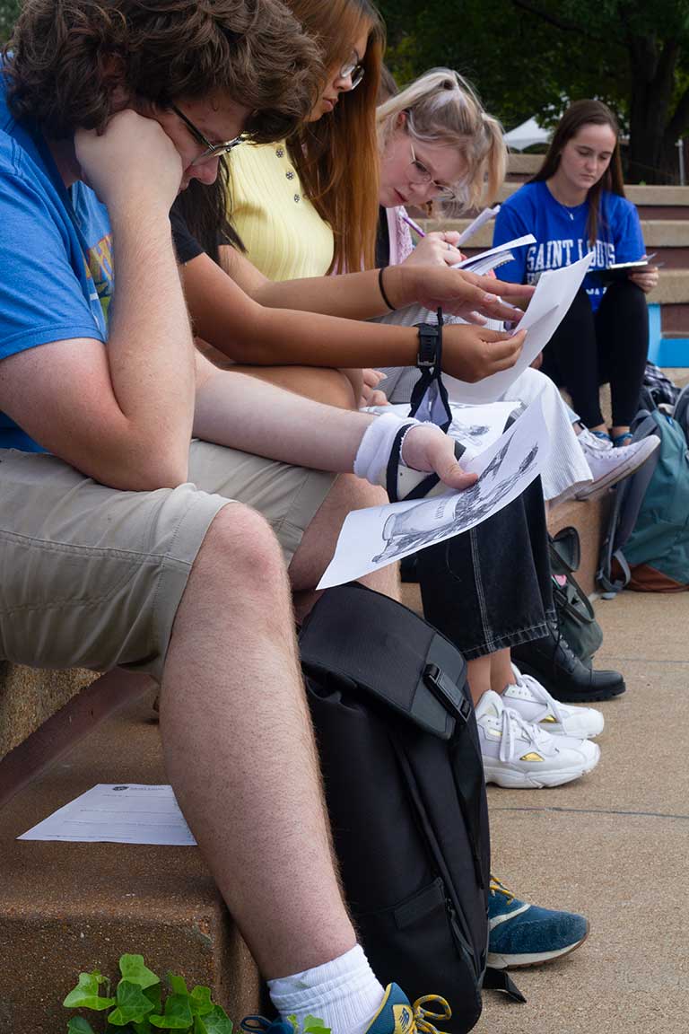 Slide 5 : A group of students listening on the clockt ower stairs