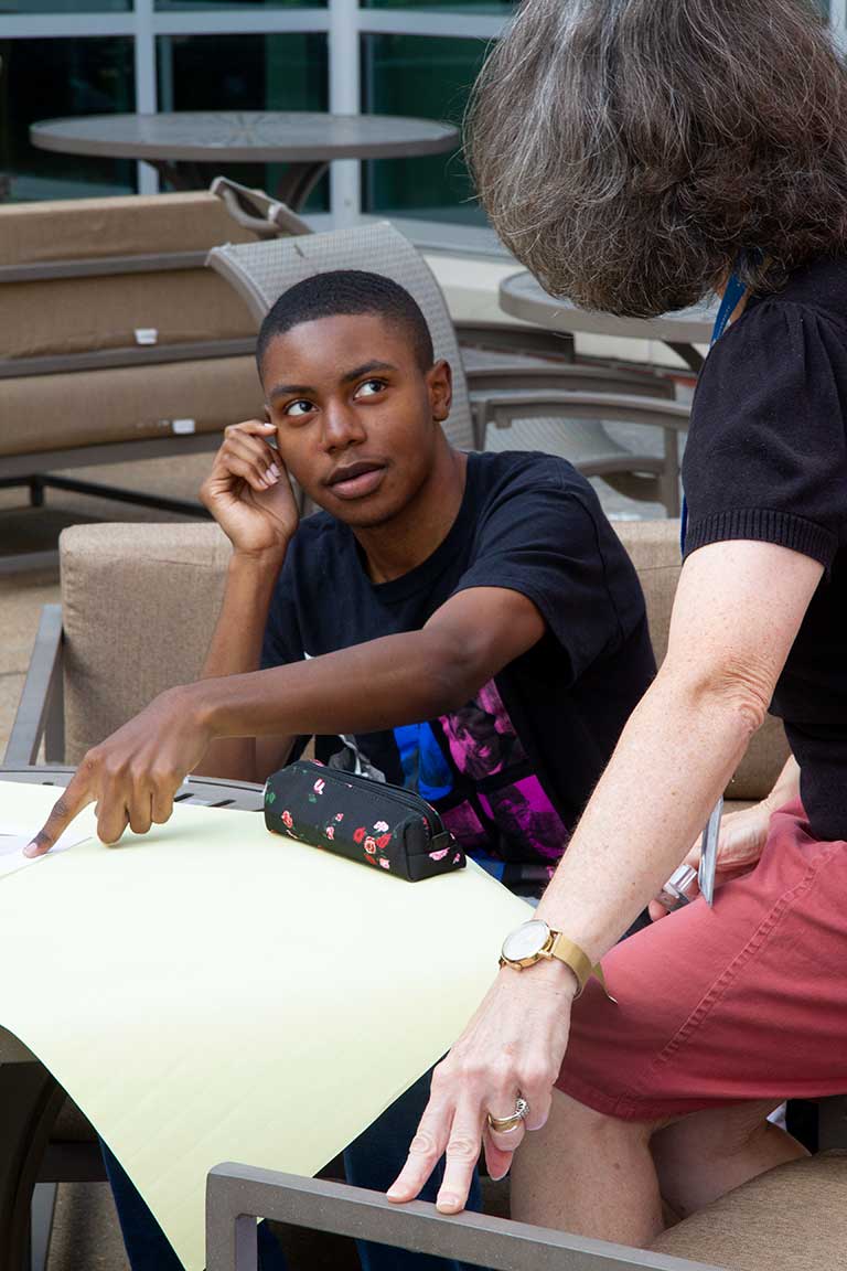 Slide 4: Student engages with instructor of Ignite Communication Seminar