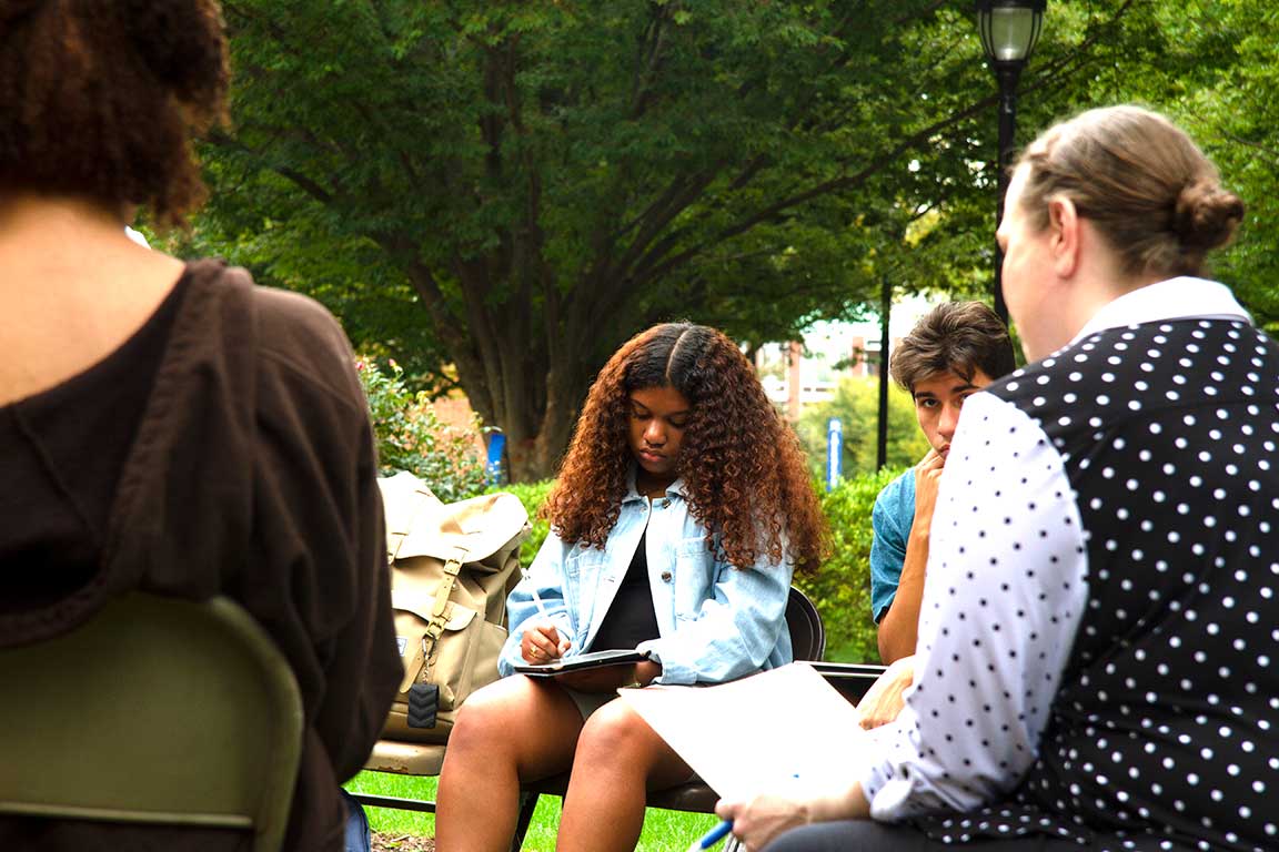 Faculty and students discuss Core in outdoor setting