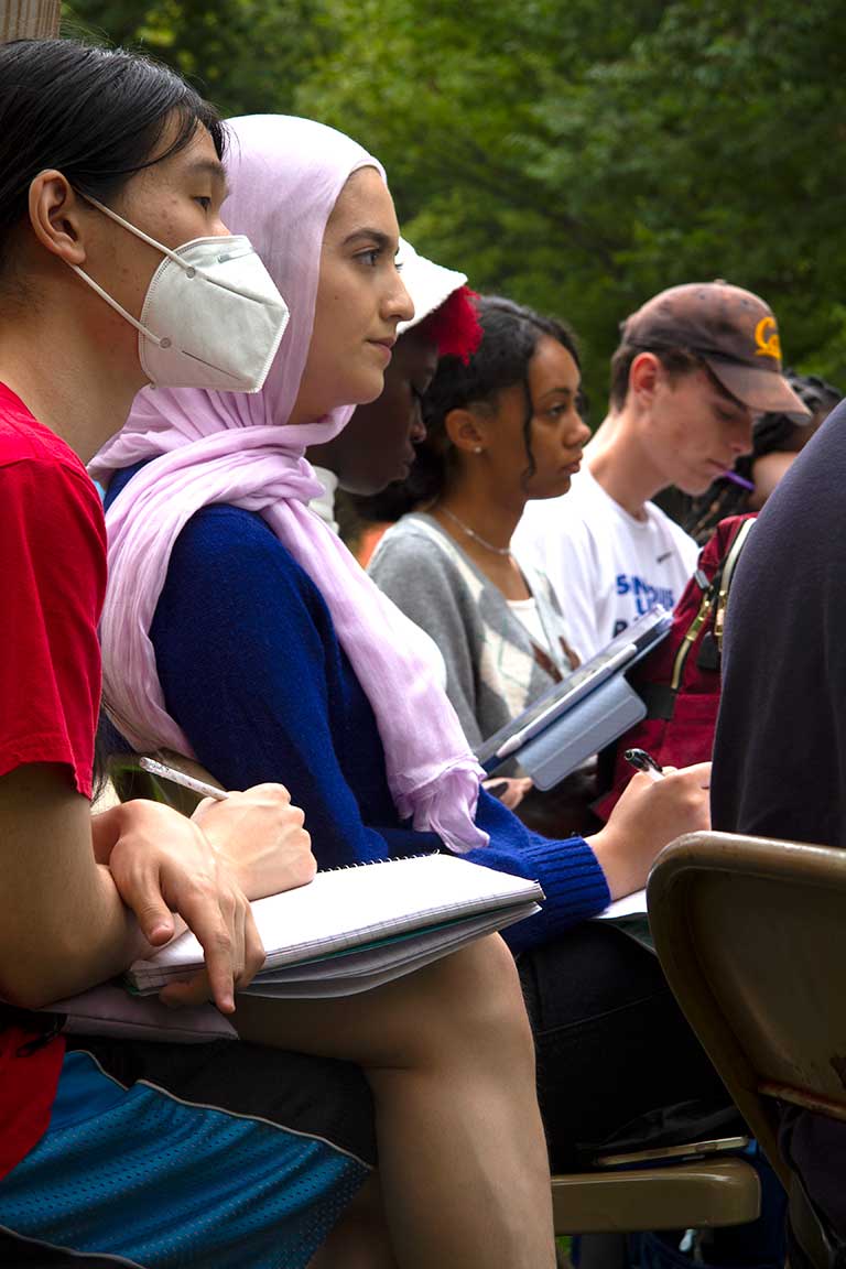 Several students discuss Core in outdoor setting