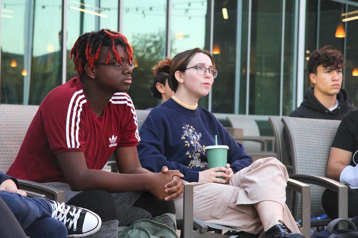 Slide 1: Students listen as they look on toward the front of the presentation