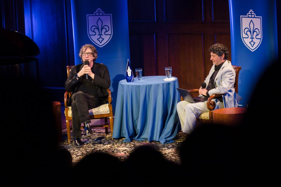 Neil Gaiman, left, speaks with Edward Ibur, executive director of the St. Louis Literary Award. Photo by Sarah Conroy.