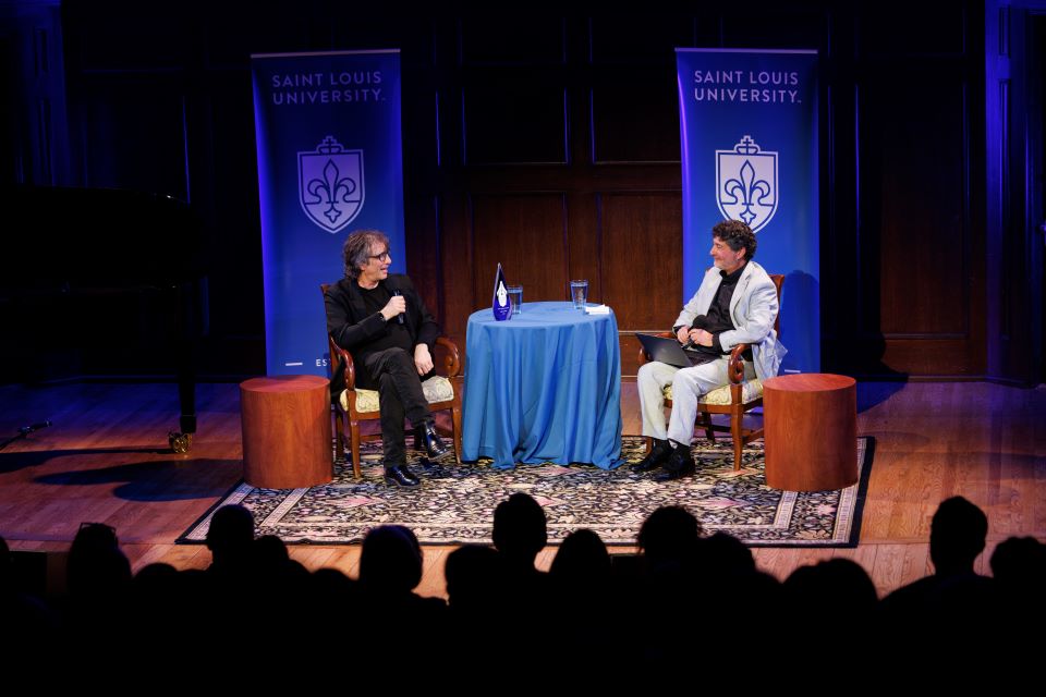 Neil Gaiman, left, speaks with Edward Ibur, executive director of the St. Louis Literary Award. Photo by Sarah Conroy.
