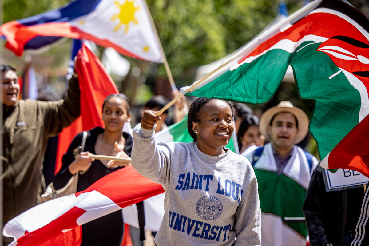 Students wave flags from countries during the Parade of Nations as part of Atlas Week on April 21, 2023. Photo by Sarah Conroy. 