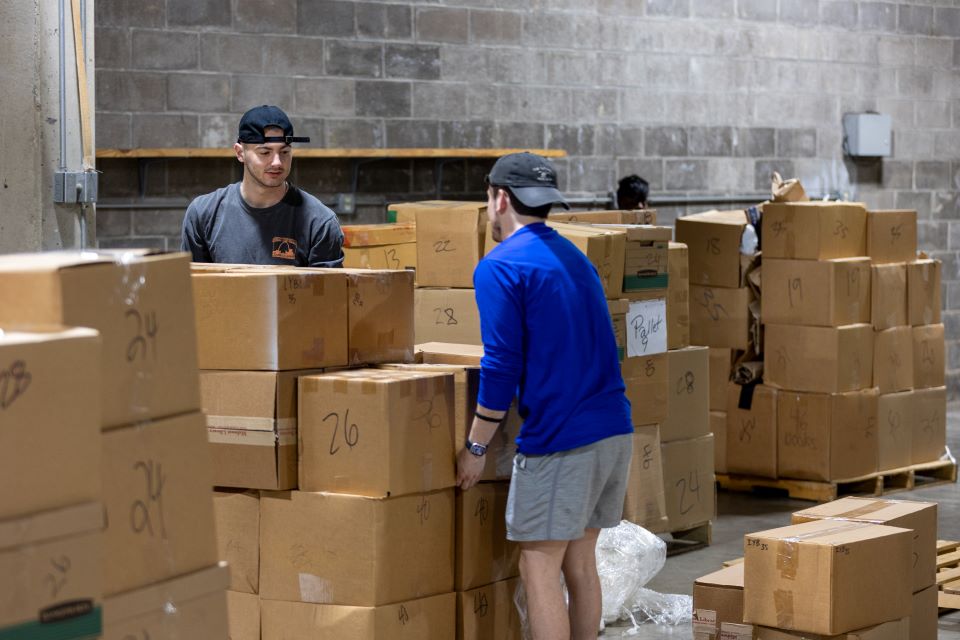 Volunteers stack boxes of books. Photo by David Malone. 