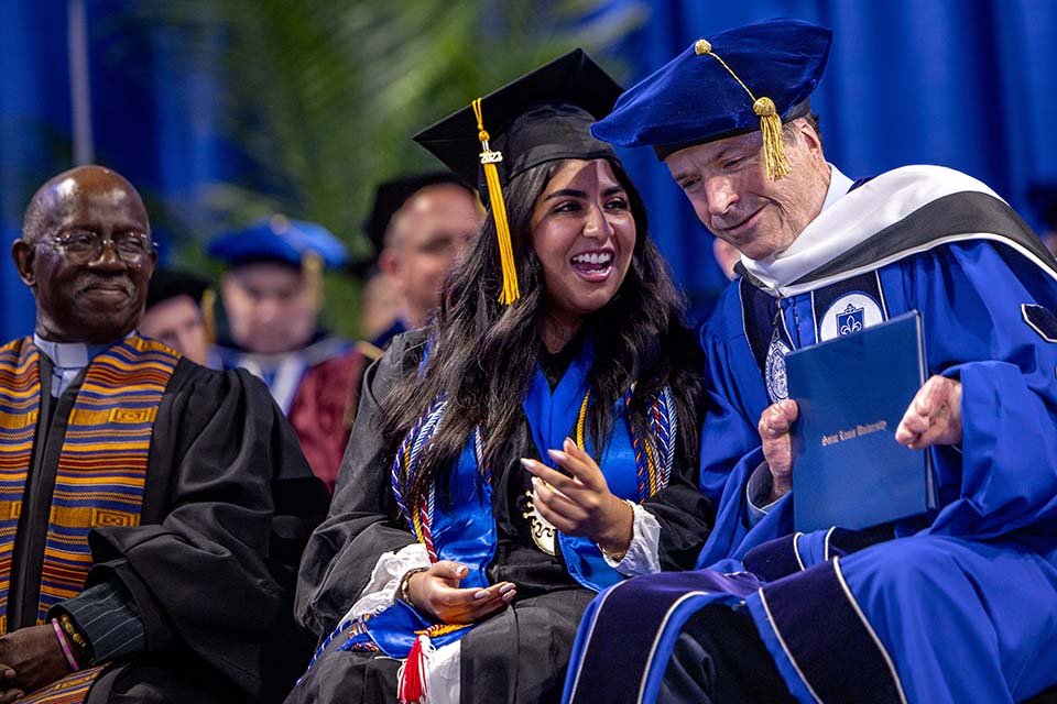 Student speaker Zahva Naeem and commencement speaker John O'Leary share a moment during the Spring 2023 Commencement Ceremony on Saturday, May 20. Photo by Sarah Conroy.