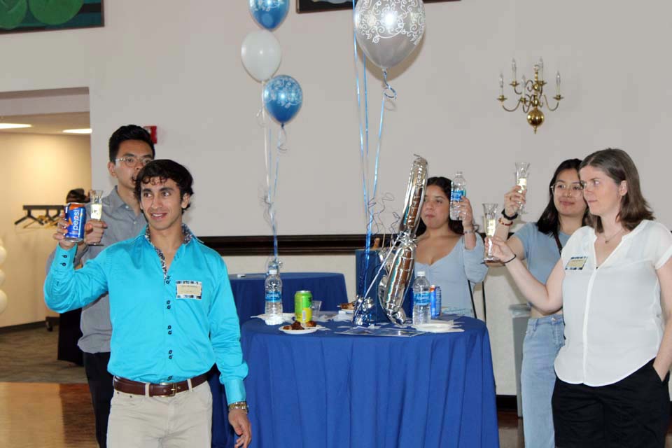 International students share a toast during a celebration on Wednesday, May 17. Photo by Joe Barker.