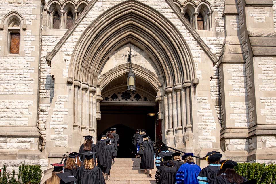 School of Education graduates file into St. Francis Xavier College Church for their precommencement on May 18, 2023. Photo by Sarah Conroy.